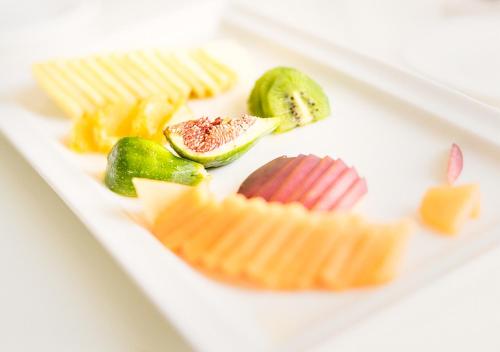 a plate of different types of cheese and pickles at Hotel Ovidius in Sulmona