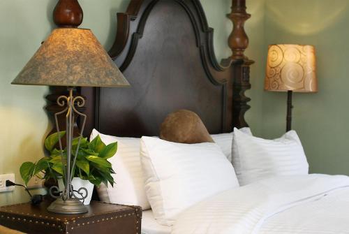 a bed with a lamp on a table with pillows at D & S in Luodong