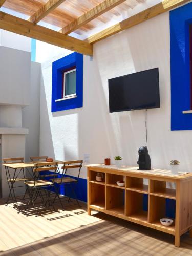 a living room with a tv on a wall at Solar do Alentejo in Cercal