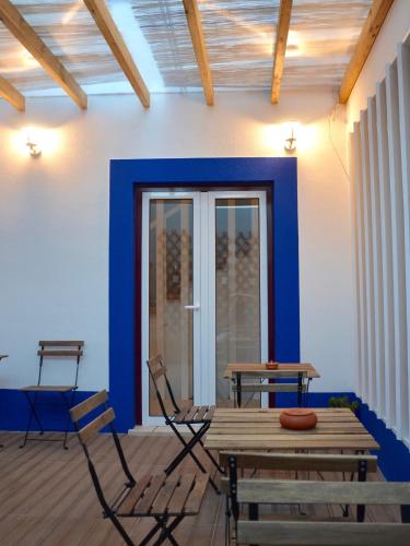 a room with two chairs and a wooden table at Solar do Alentejo in Cercal