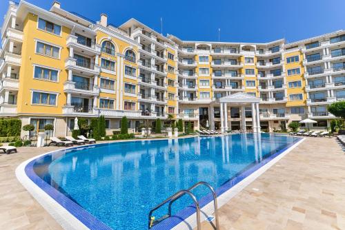 a large swimming pool in front of a building at VILLA FLORENCE Boutique Apart Hotel in Sveti Vlas