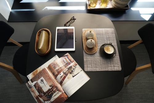 a round table with a book and a tablet on it at MD Design Hotel - Portal del Real in Valencia