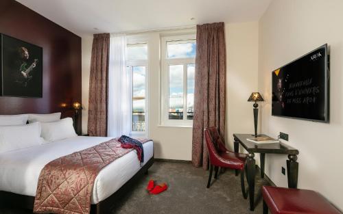 a hotel room with a bed and a window at Hotel Arok in Strasbourg