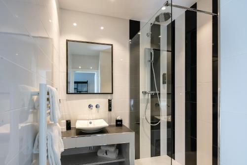 a bathroom with a sink and a shower at Hotel Arok in Strasbourg