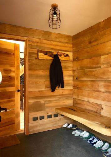 a room with a wooden wall with a bench at Chalet Ciprés in Las Trancas
