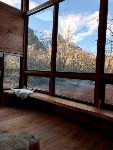 a room with a window with a view of a mountain at Chalet Ciprés in Las Trancas