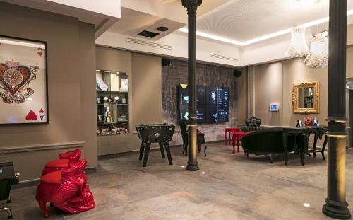 a restaurant with tables and chairs in a room at Hotel Arok in Strasbourg