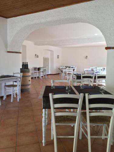 a dining room with white tables and white chairs at Albergo Ristorante Belcantone in Novaggio
