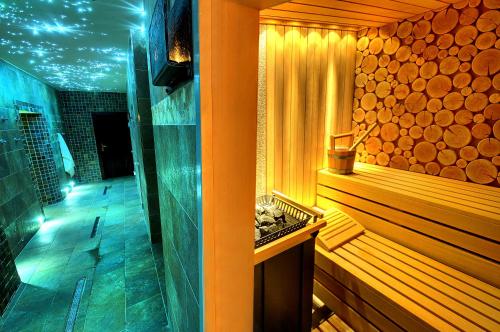a bathroom with a sauna with a wooden tub at Grand Hotel Praha in Tatranská Lomnica