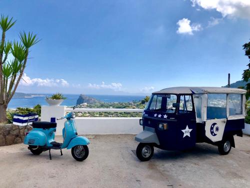 a small golf cart parked next to a scooter at Relais Bijoux Ischia in Ischia