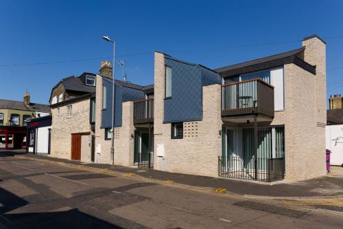 a row of brick houses on a street at Citystay Living - Devonshire Road in Cambridge