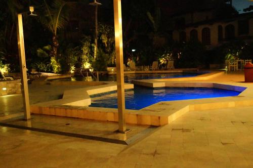 a swimming pool at night with blue water at Grand Hotel Mercedes in Pucallpa