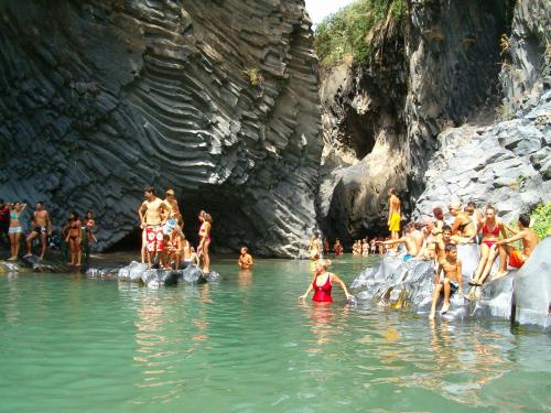 a group of people swimming in the water at Cottage Gole Alcantara Gloria Room in Graniti