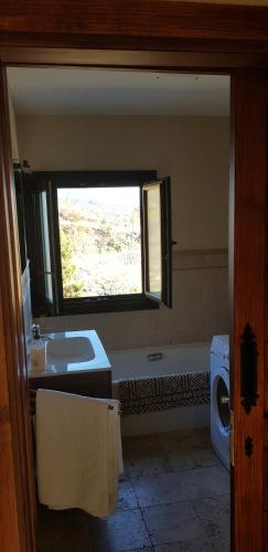 a bathroom with a tub and a sink and a toilet at My hell Village in Tijarafe