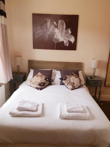 a bedroom with a bed with towels on it at The Red Lion in Kilsby
