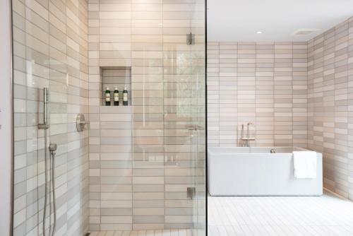 a bathroom with a glass shower with a sink at Harmon Guest House in Healdsburg