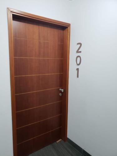 a wooden door with the number written on it at Residencial Cafferata in Lima