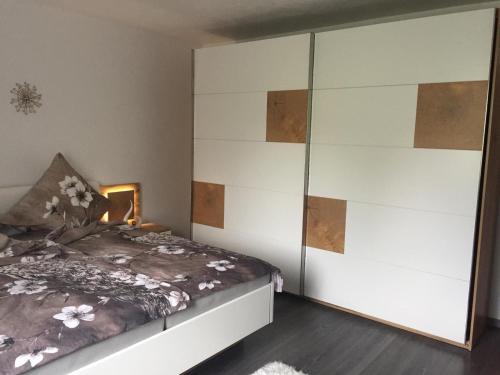 a bedroom with a bed and a large cabinet at Ana‘s Ferienwohnung in Furth im Wald