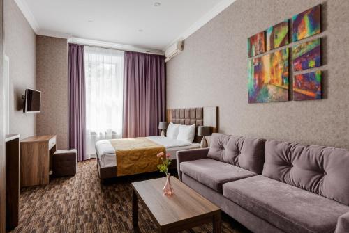 モスクワにあるFlorinn hotelのソファとベッド付きのホテルルーム