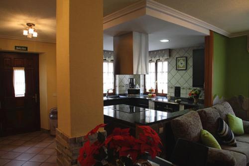 un soggiorno con divano e cucina di Vivienda Rural La Mazuga a Cabárceno