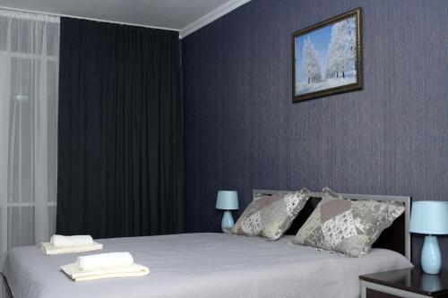 a bedroom with a bed with two towels on it at Georgian Hosts Tbilisi in Tbilisi City