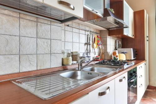 a kitchen with a sink and a stove at Casa Vacanze Bellavista in San Casciano in Val di Pesa