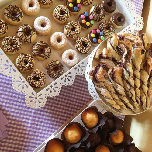 a table with two trays of different types of donuts at Agriturismo Casa Aurora in Bussolengo
