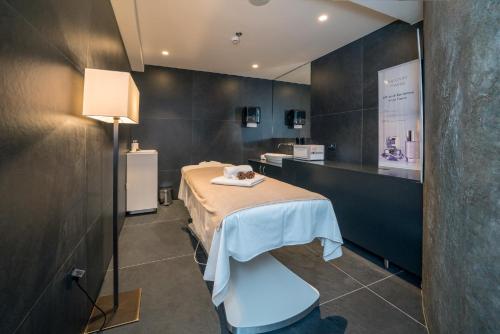 a room with a bed with a table in it at Bellevue Superior City Hotel in Šibenik