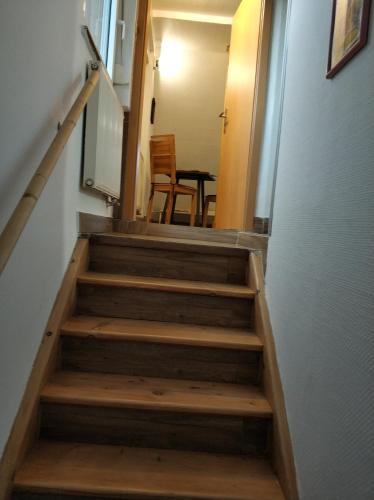 a staircase leading up to a room with a table at Lovely Studio in Cannstatt in Stuttgart