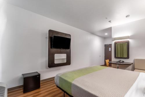 
a hotel room with a television and a bed at Motel 6-Las Vegas, NV - Motor Speedway in Las Vegas
