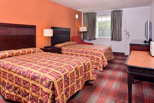 a hotel room with two beds and a window at Americas Best Value Inn Richmond South in Richmond
