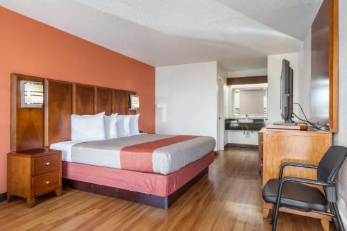a hotel room with a bed and a television at Motel 6-Van Buren, AR I- 40 in Van Buren