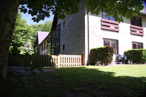 a building with a fence in front of a yard at Hovborg Kro in Hovborg
