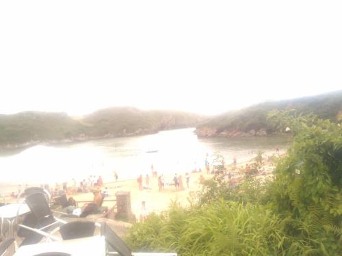 a group of people on a beach near the water at Villa maria in poo de Llanes