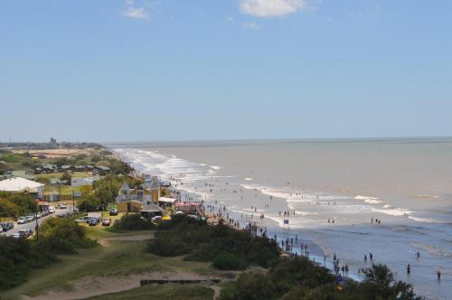 a view of a beach with people on it at Hotel Golf Internacional in Santa Teresita