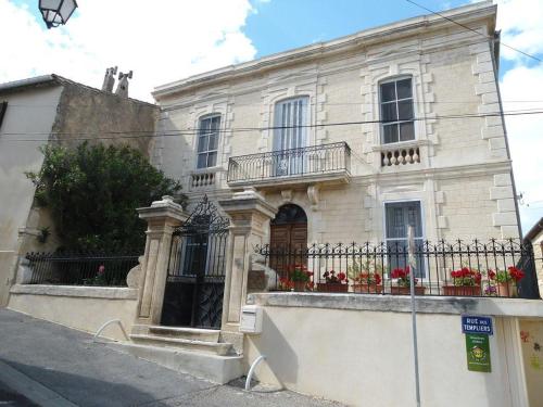 a white building with flowers on the front of it at Couleurs De Camargue in Beauvoisin