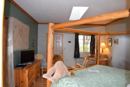 a little girl sitting on a bed in a bedroom at The Inn of Escalante in Escalante