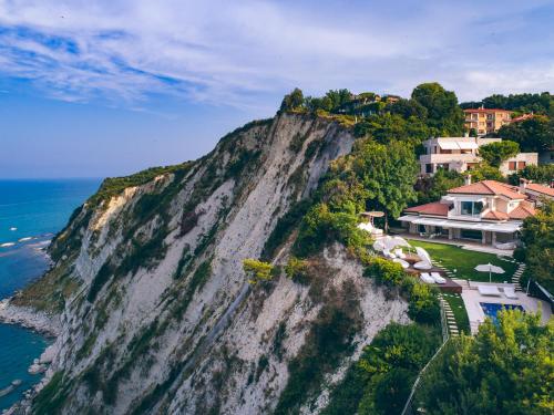 an aerial view of a house on a cliff next to the ocean at Villa STAMIRA in Ancona