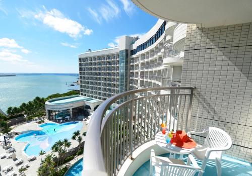 an apartment balcony with a view of the ocean at Loisir Hotel Naha in Naha