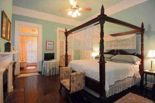 a bedroom with a large bed and a large window at 1872 Denham Inn in Monticello