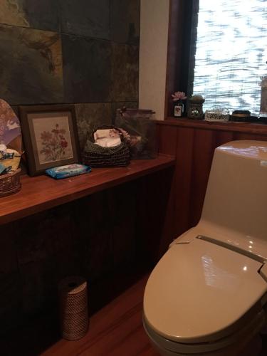 a bathroom with a white toilet and a window at Kasumi-an in Kumamoto