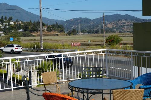 a patio with a table and chairs on a balcony at Muir Woods Lodge in Mill Valley