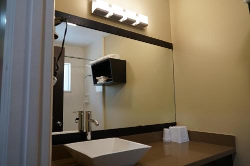 a bathroom with a sink and a mirror at Muir Woods Lodge in Mill Valley