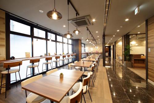 a row of tables and chairs in a restaurant at Hotel Oriental Express Osaka Shinsaibashi in Osaka