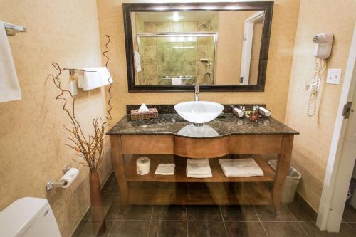 a bathroom with a sink and a mirror at Best Western Sicamous Inn in Sicamous