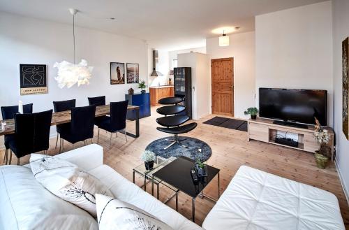 a living room with a white couch and a tv at Fredericia Apartment II in Fredericia