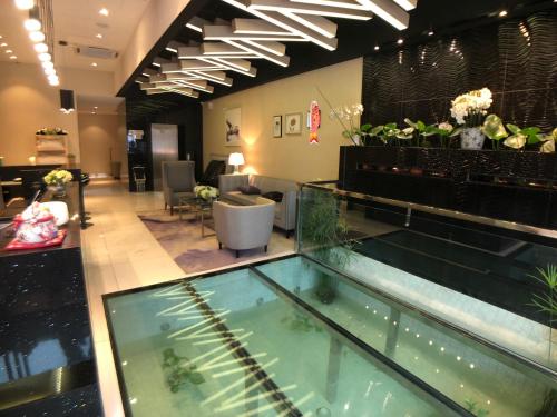a lobby with a aquarium in the middle of it at Kyoto Boutique Hotel in Johor Bahru