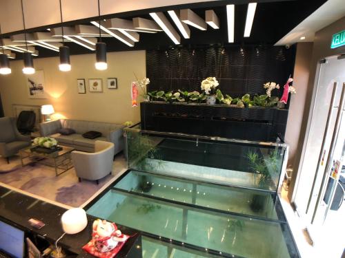 a room with a fish tank in a room at Kyoto Boutique Hotel in Johor Bahru