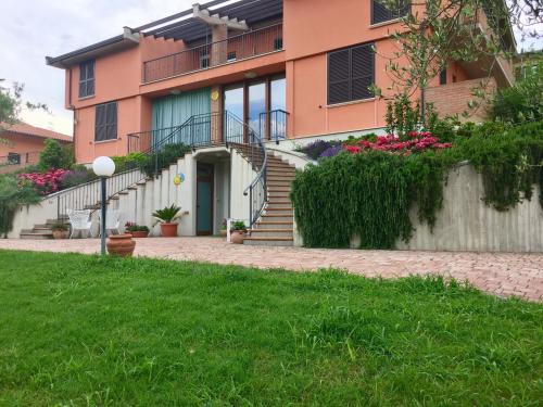 a house with a staircase and flowers in front of it at B&B Sole Luna in Perugia
