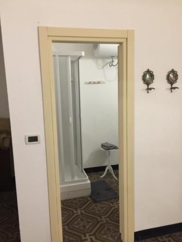 a doorway into a room with a mirror and a stool at Cà Bartolomeo in Finale Ligure